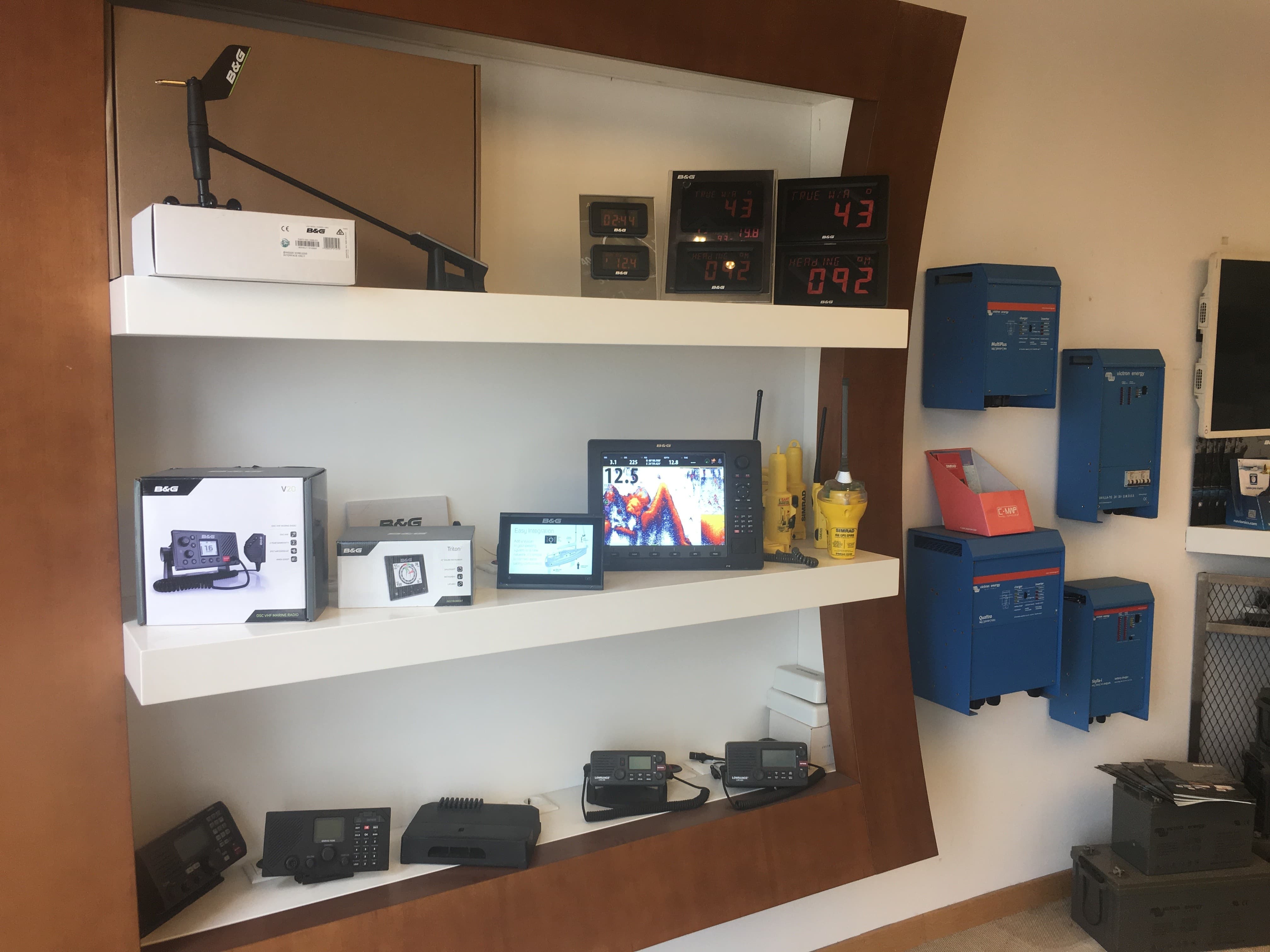 Three shelves of electronic devices for sale