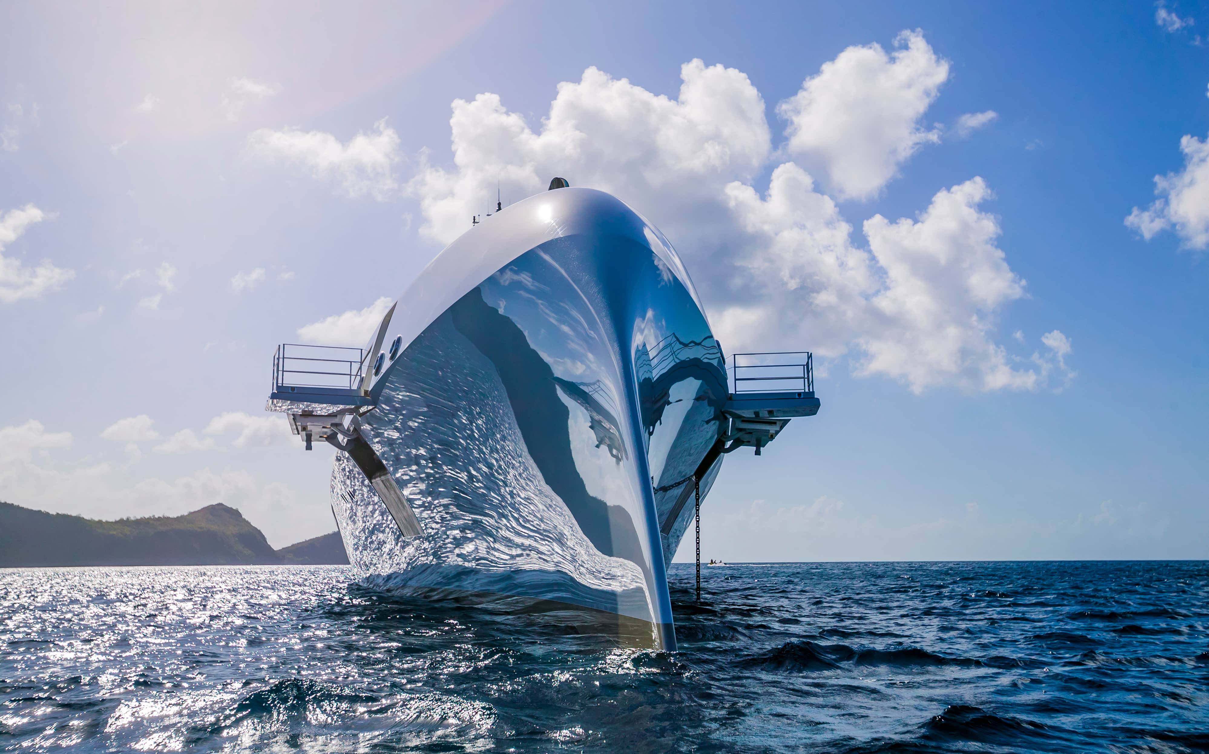 Yacht at sea with water reflecting off chrome front