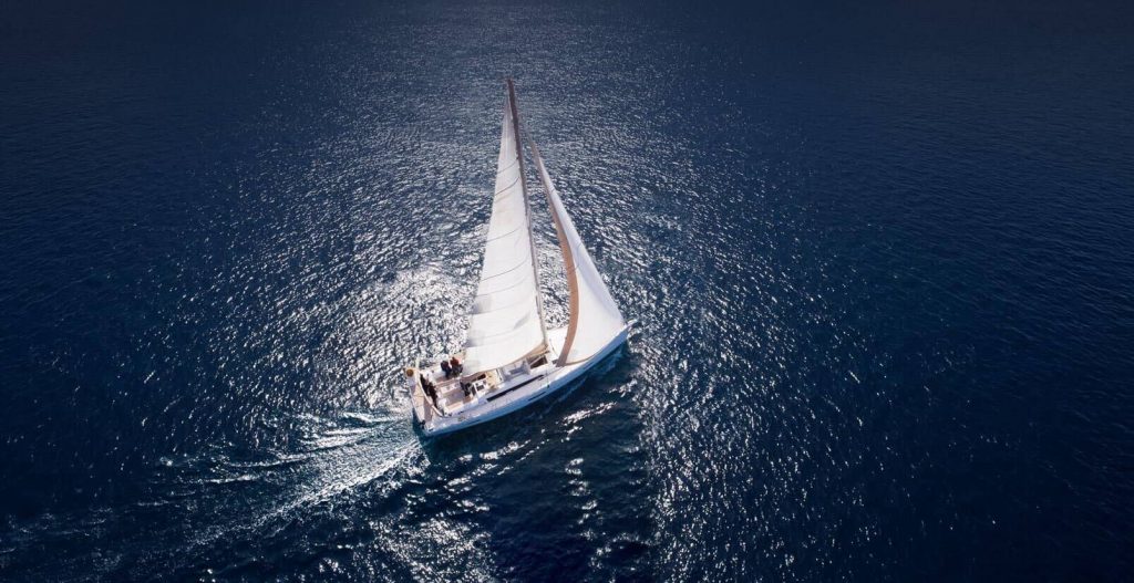 White sailboat at sea from above