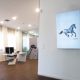 Office with white desk and poster of horse running