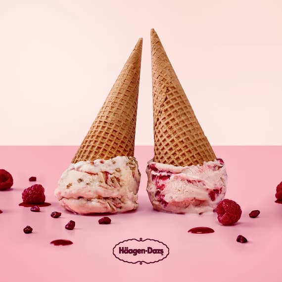 Haagen Dazs advertisement with two cones of raspberry ice cream facing down