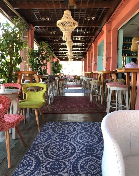 Interior of Boho Sea Life with colorful chairs in Flisvos Marina