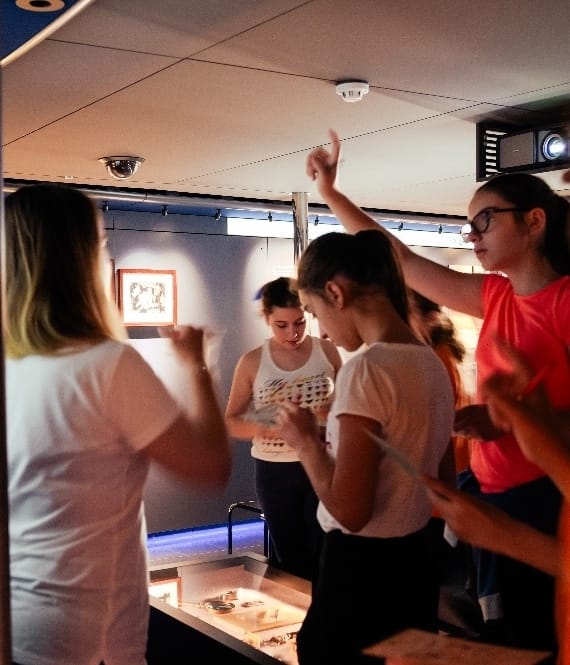 Four females watching a projector image