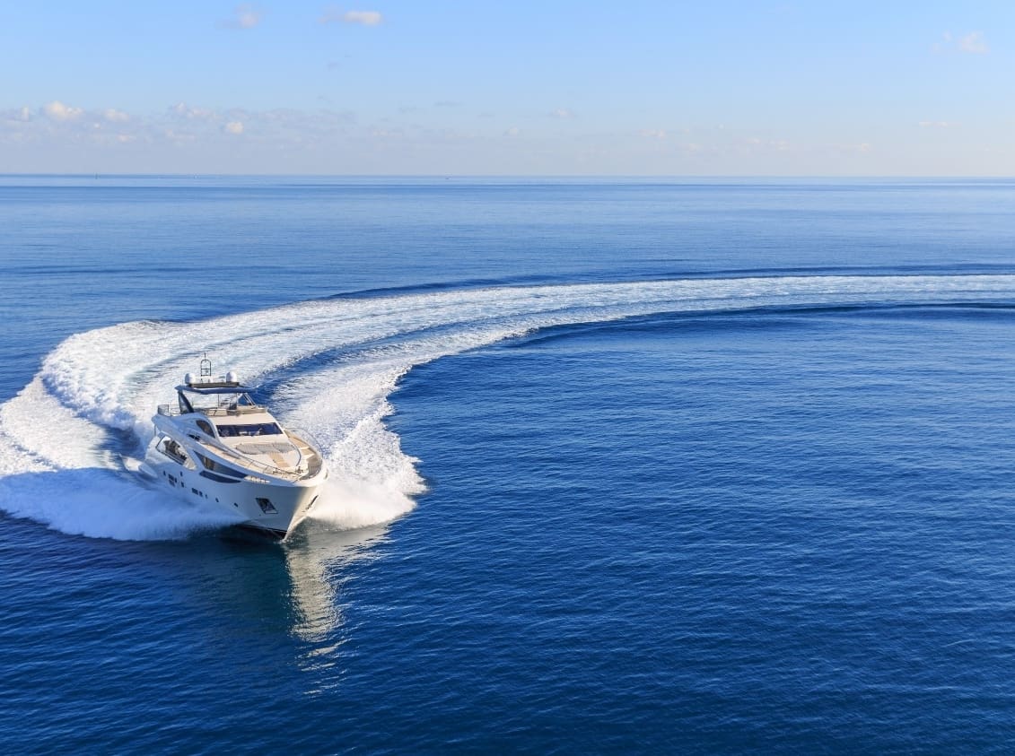 Yacht driving in sea creating waves