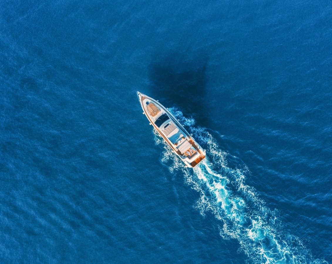 Aerial photograph from above white yacht driving in sea